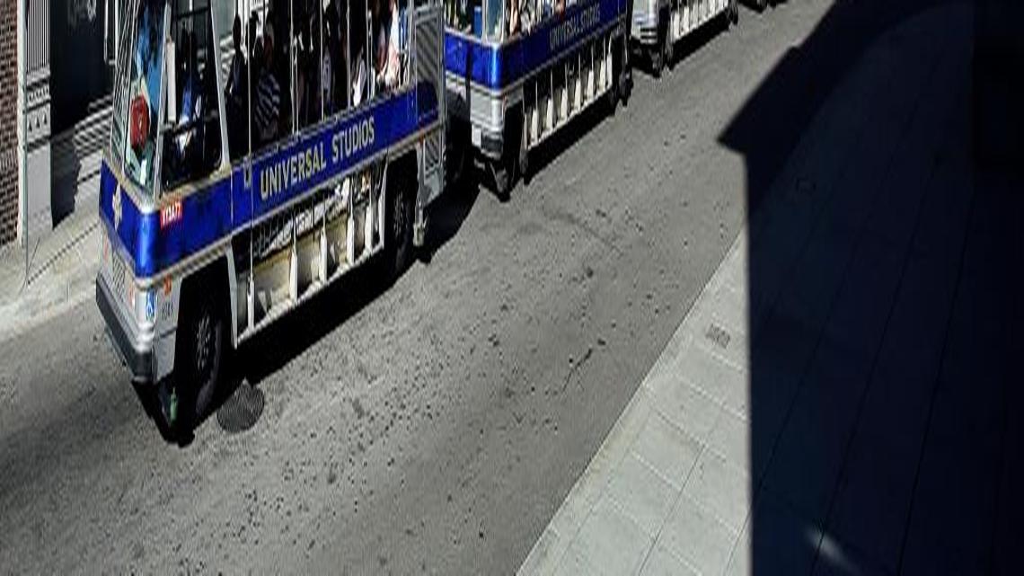 Tourists ride the tram past the Metro Set during the Studio Tour at Universal Studios Hollywood.