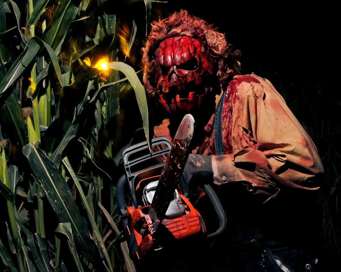 A chainsaw-wielding actor awaits guests at last year’s Raisin Hell Ranch in Madera.