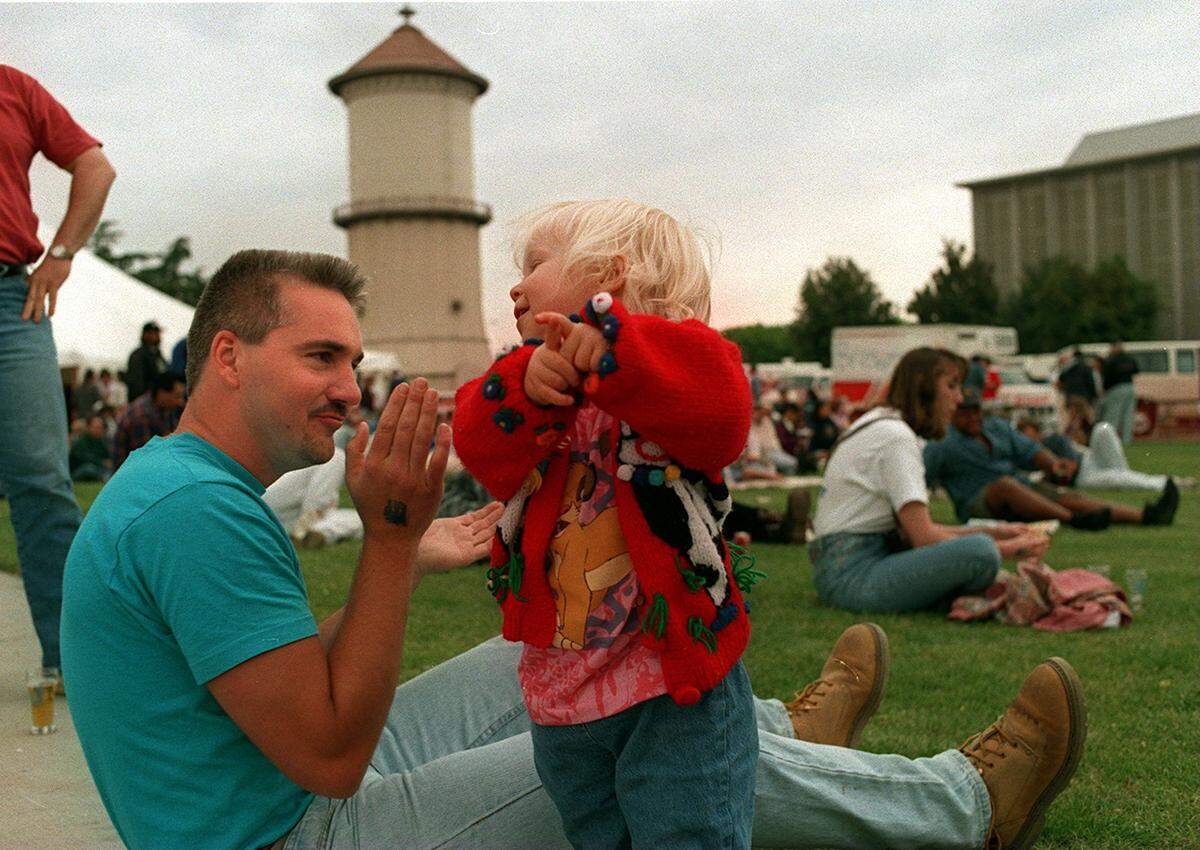 Johnny Cocco from Philadelphia, and Caitlin Huffman , 2, of Fresno listen to jazz at the First Annual Central California Micro-Brewery / Music Festival held in downtown Fresno. The event was called Sudz in the City.