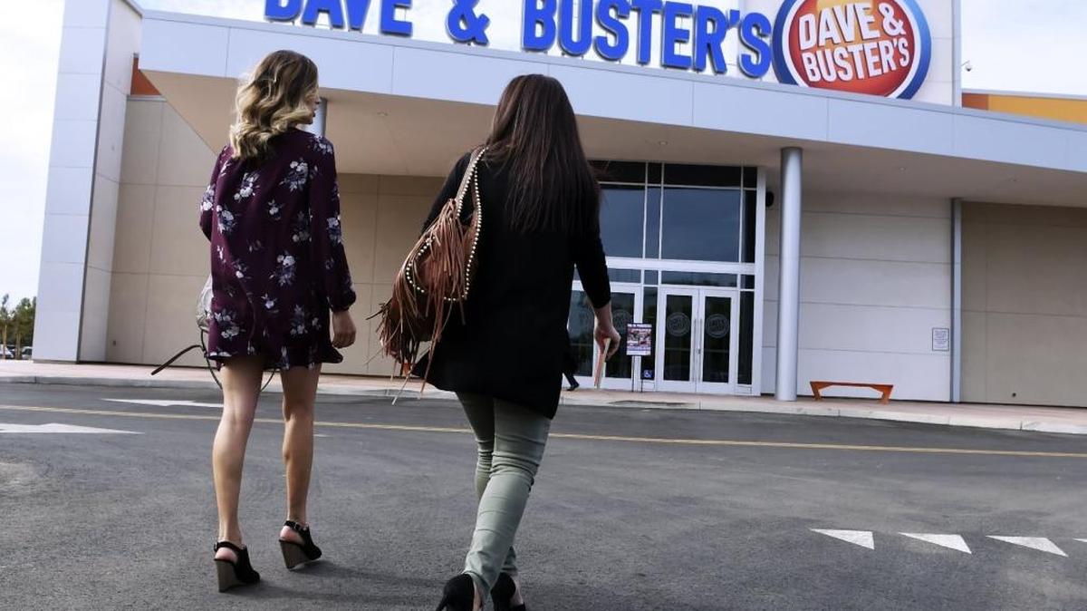 Two guests arrive for a media open house at the new Dave & Buster’s.
