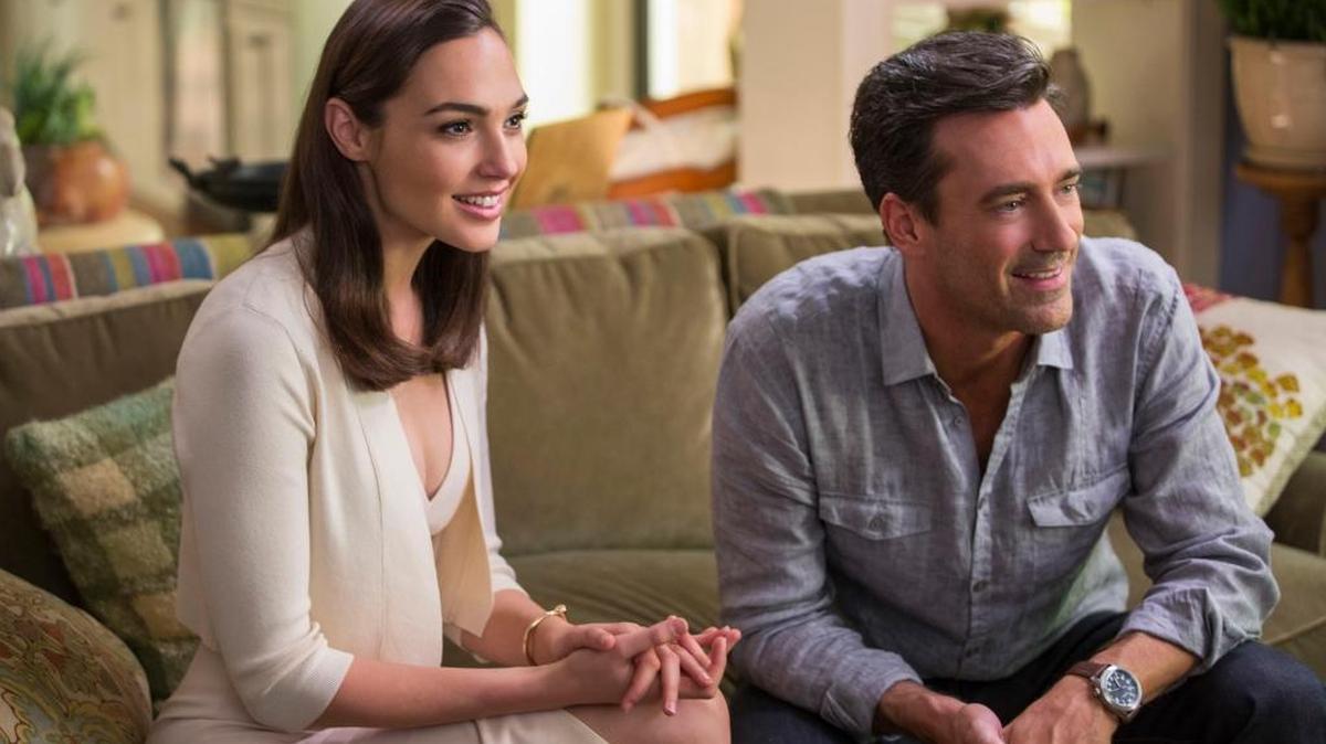 Gal Gadot, left, and Jon Hamm star in “Keeping Up With The Joneses.”