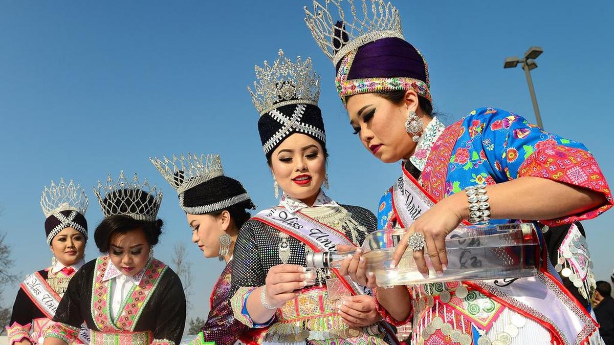Miss Hmong 2016 Nu Vang, right, pours rice wine for guests with the help of Maixai Vue, Miss Hmong 2011, and past queesn during a blessing ceremony to open the first day of a Hmong New Year celebration put on by the United Hmong Council of Fresno at Calwa Recreation and Park District in Fresno in 2016.