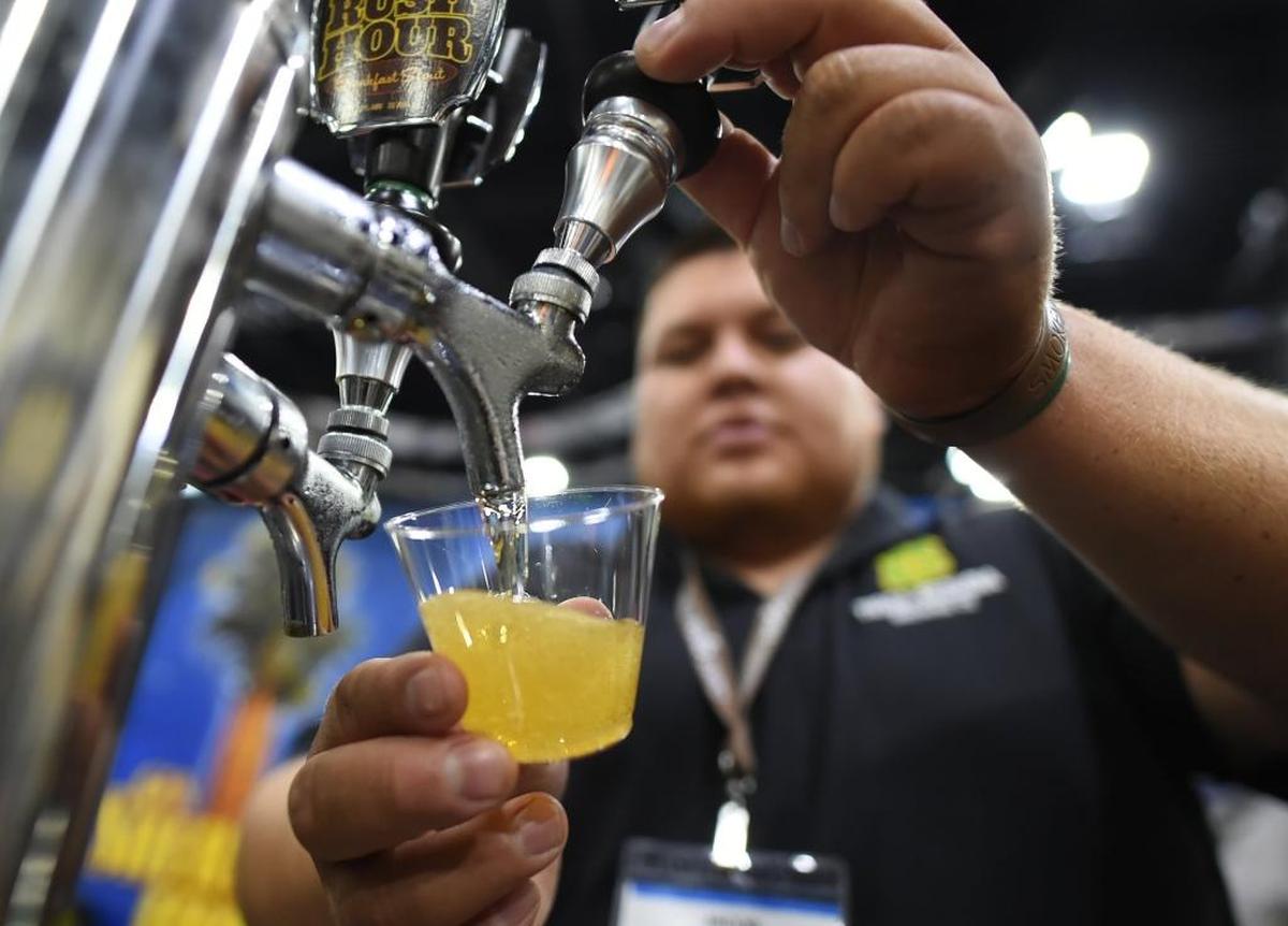 Jacob Moraga of Tioga-Sequoia Brewing Company pours a sample of California 99 Golden Ale during the 2016 Fresno Food Expo. This year’s event is July 27.