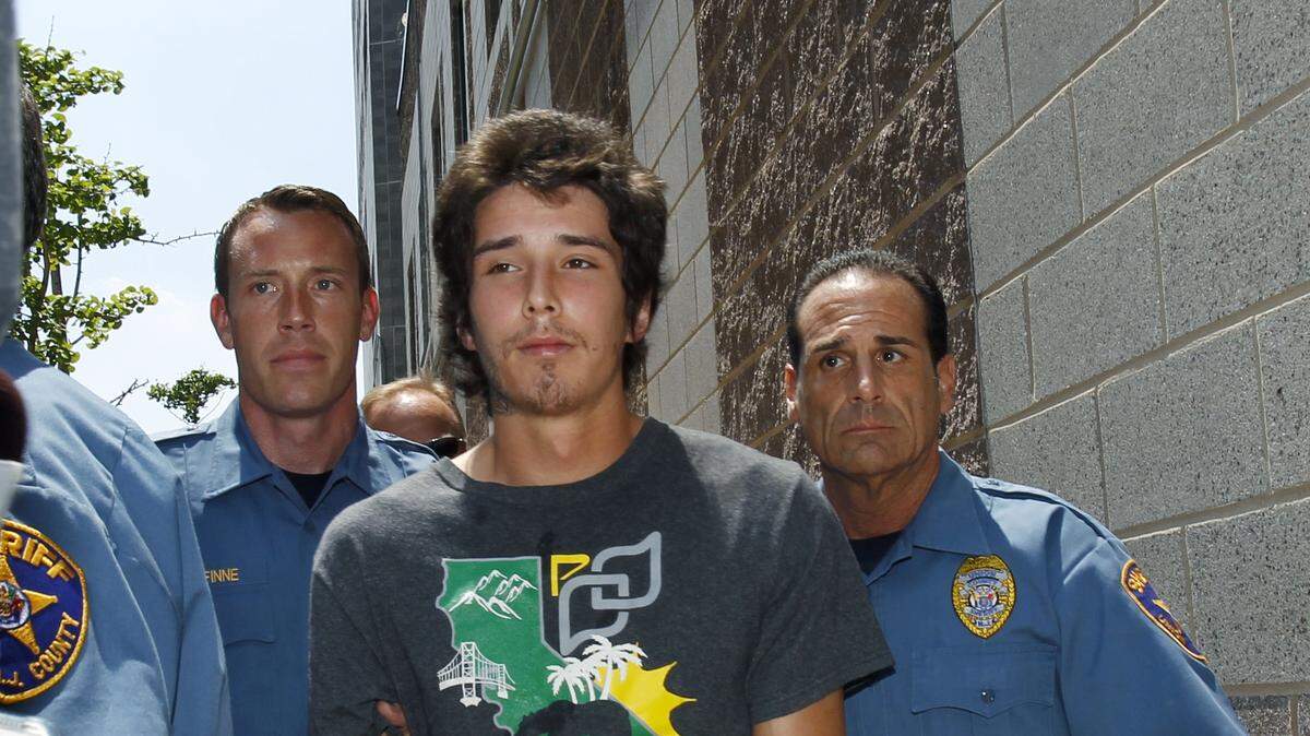 Caleb “Kai” McGillvary, 24, is taken by Union County sheriff’s officers to jail in Elizabeth, N.J., Thursday, May 30, 2013. McGillvary is charged with beating 73-year-old lawyer Joseph Galfy to death after they met in New York City. Galfy’s body was found in his Clark, N.J., home. McGillvary, who gained Internet fame as “Kai, the hatchet-wielding hitchhiker,” says he’s not guilty of the murder charge. (AP Photo/Mel Evans)
