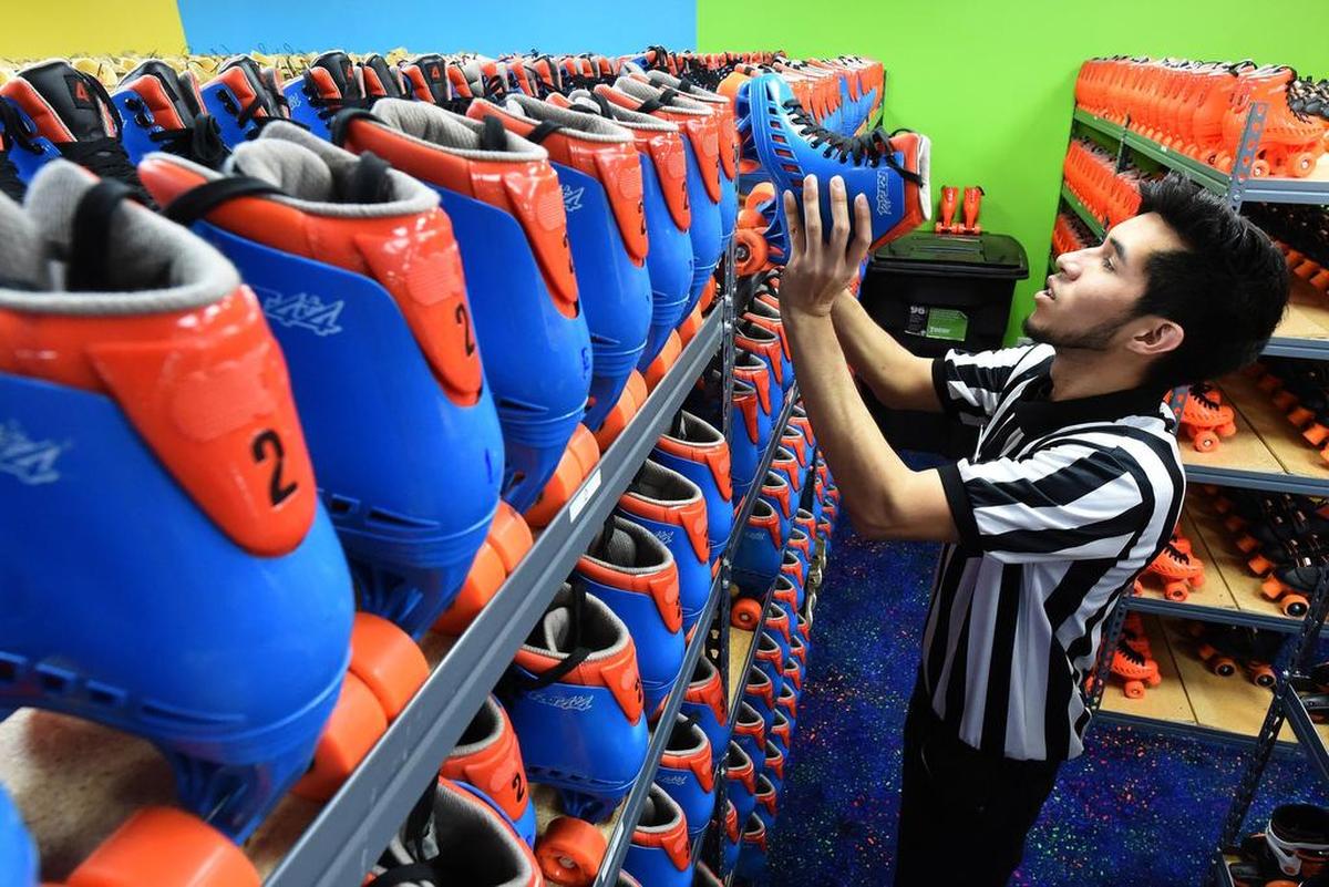 United Skates of America employee Jesse Alvarado readies skates for the crowd on Saturday, April 6, 2019.