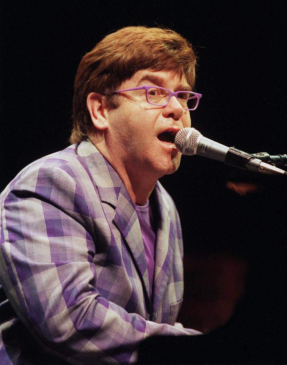 Elton John belts out a tune during his stop at Selland Arena in Fresno in May 1999.