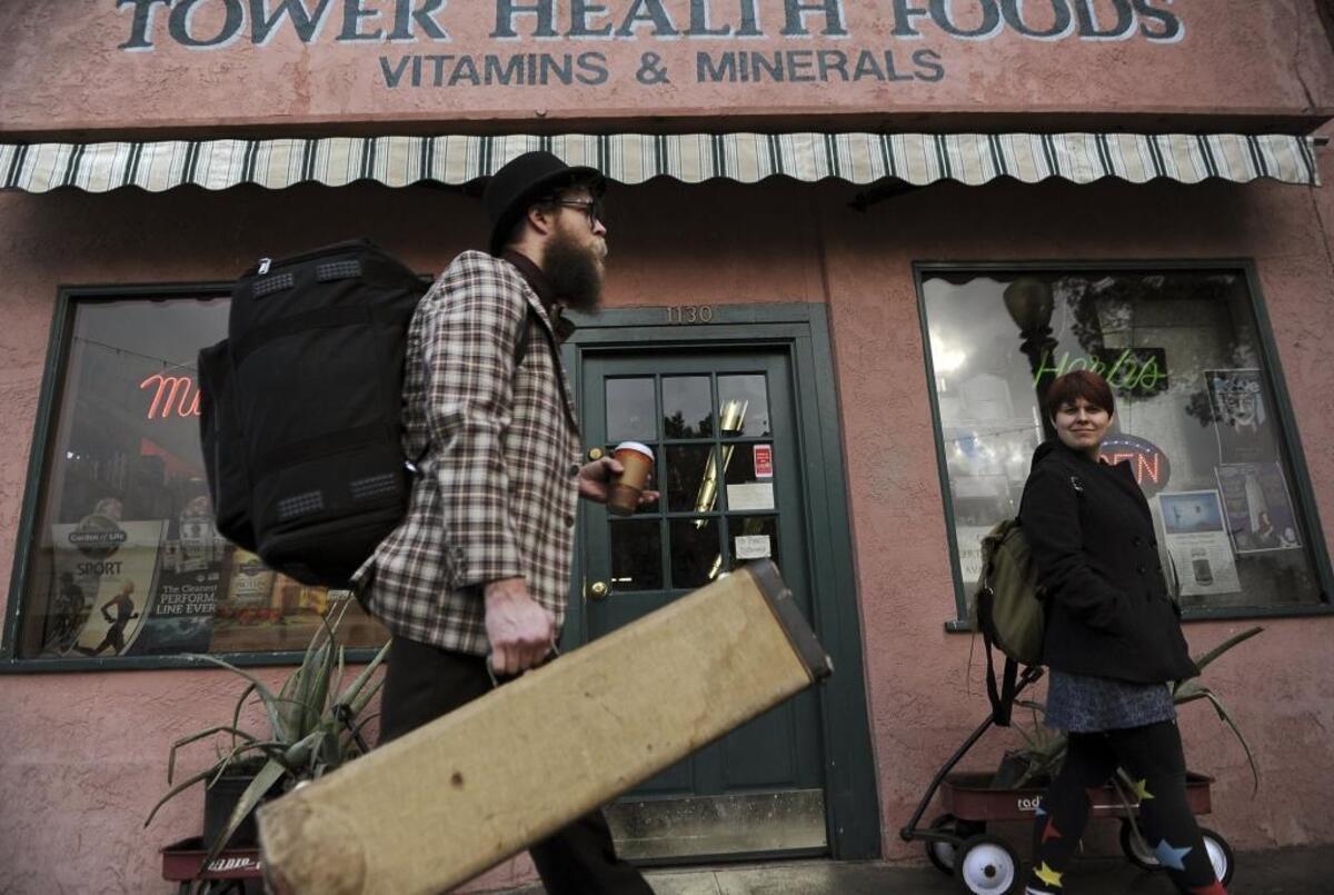 Strangely, left, a returning Rogue Festival performance artist, walks to the next Tower District venue for his Joy Compactor show at the 2017 Rogue Festival.