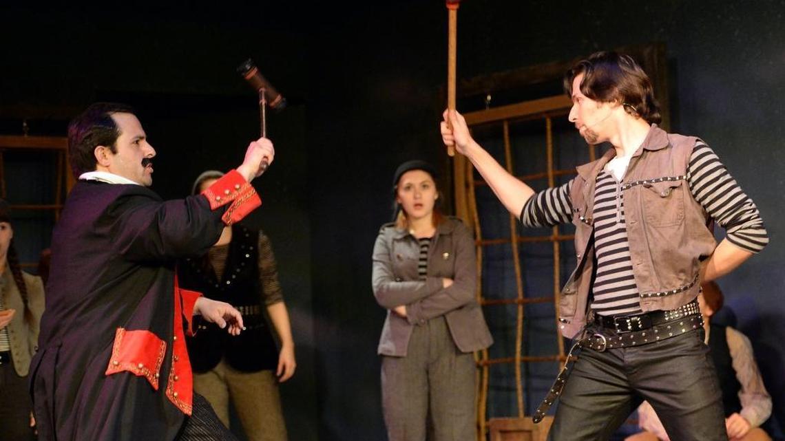 Cast member Mallory Parker, center, watches as Teddy Maldonado, left, as The Black Stache, uses a croquet mallet in a “sword” fight against Jesse McCoy, right, as Slank, who uses a toilet plunger, in Good Company Players’ dress rehearsal of “Peter and the Starcatcher” at Roger Rocka’s Dinner Theater in Fresno.