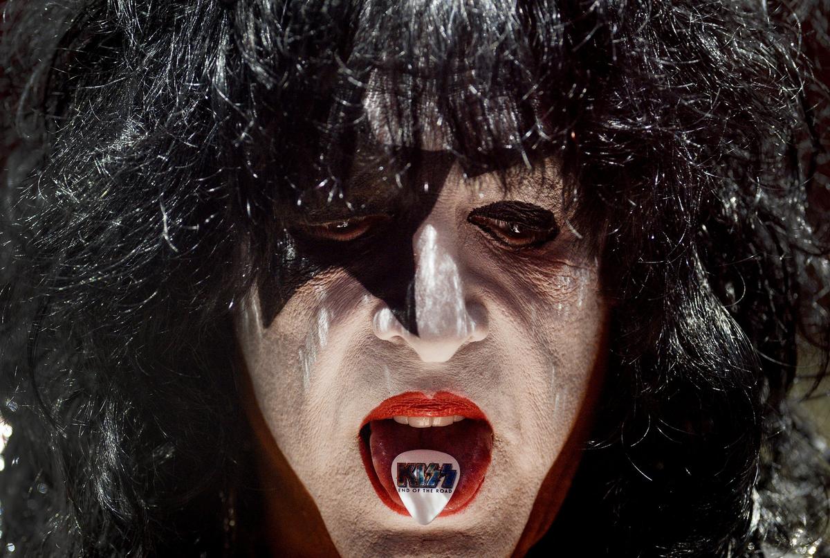 Kiss guitarist and singer Paul Stanley holds a guitar pick in his mouth while performing with the band during their End of the Road tour at the Save Mart Center in Fresno on Friday, Feb. 8, 2019.