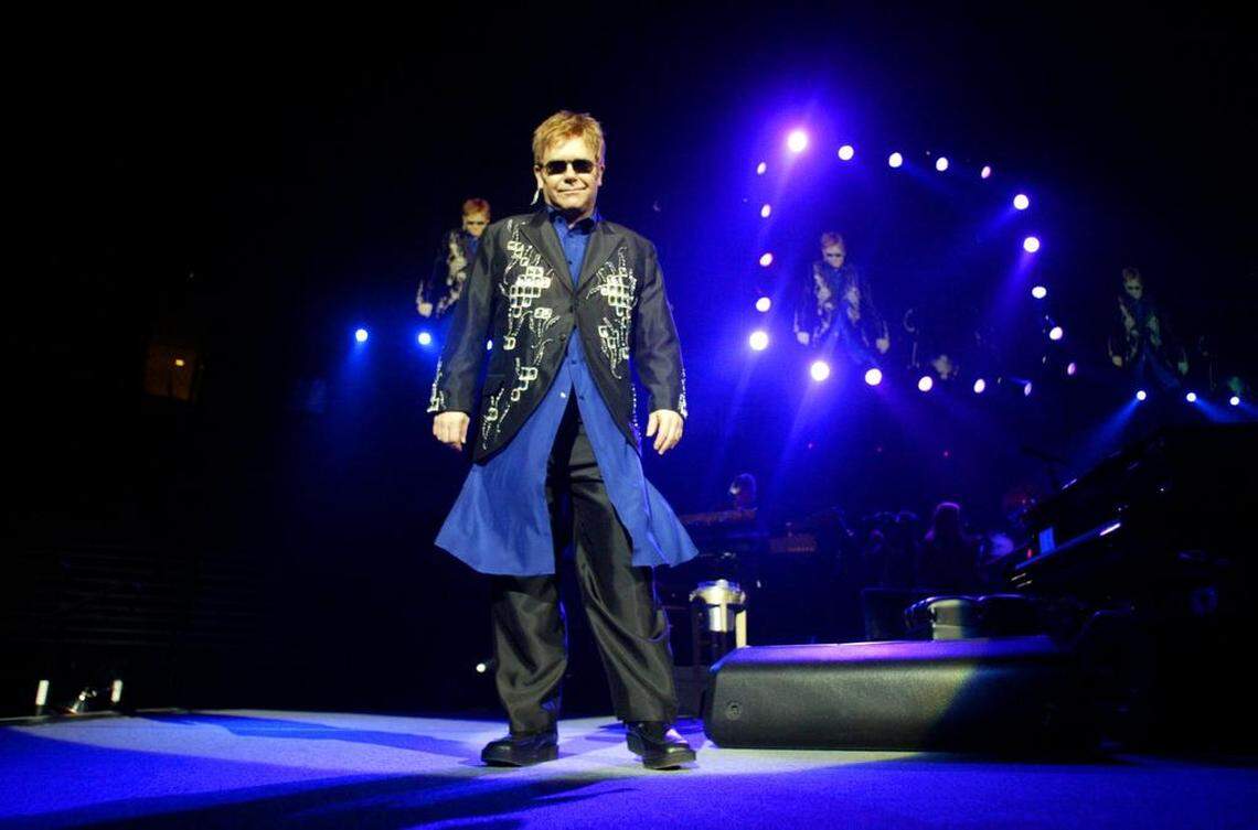 Pop musician Elton John enters the stage at the Save Mart Center for his concert on Saturday night November 8, 2003.