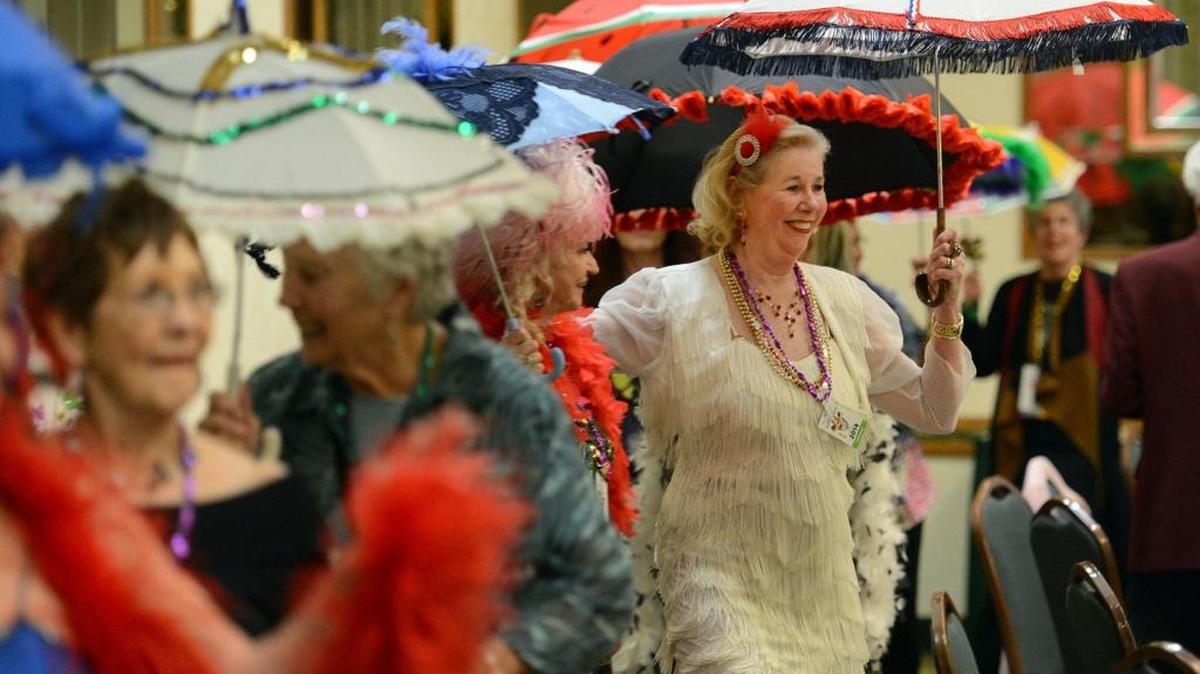 In this 2014 photo, Betty Reenalda, right, of Clovis, skips along with the annual parasol parade at the Radisson Hotel during the Fresno Dixieland Society’s Sounds of Mardi Gras event. This year’s event kicks off Friday, Feb. 11, at DoubleTree by Hilton Convention Center in downtown Fresno.