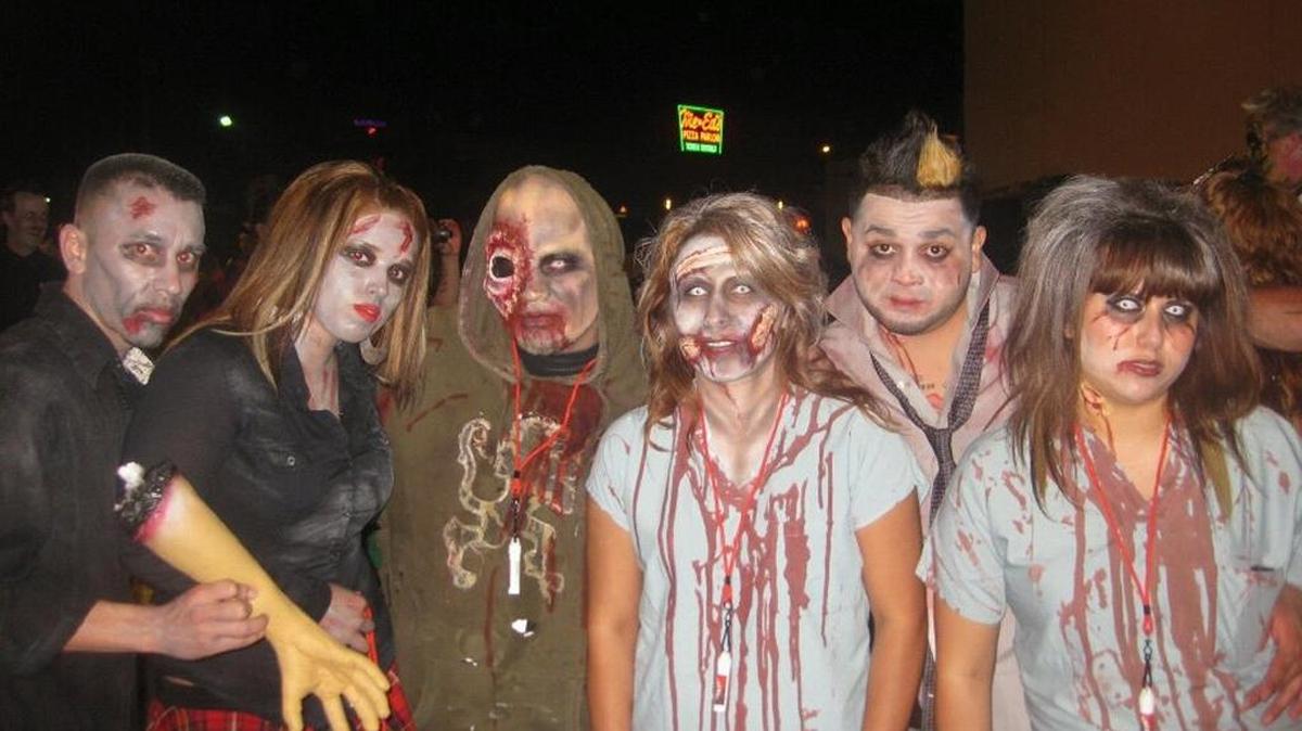 
David Gastelo, third from left in green, and friends dressed up as zombies at last year’s Zombie Pub Crawl. This year’s event is Saturday, Oct. 17, in the Tower District.

