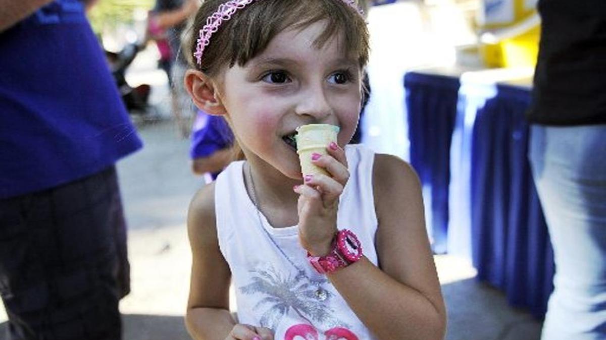 Roxanne Hardin, 5, from Clovis enjoys Bearble Gum ice cream, one of many flavors of ice cream offered during the 2015 Producers Ice Cream Zoofari. This year’s Zoofari is Aug. 5.