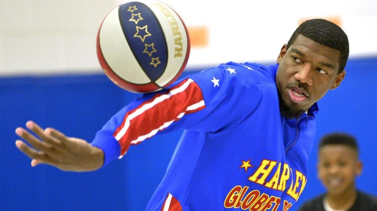 Harlem Globetrotters Anthony “Buckets” Blakes does tricks for children in North Augusta, S.C.