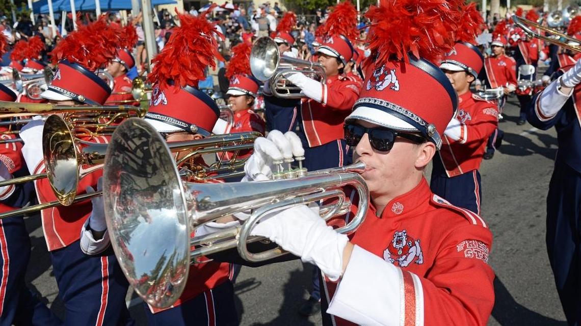 Members of the Fresno State Bulldog Marching Band perform as they pass in front of the Veterans Memorial Auditorium on Fresno Street during the 2016 Veterans Day Parade.