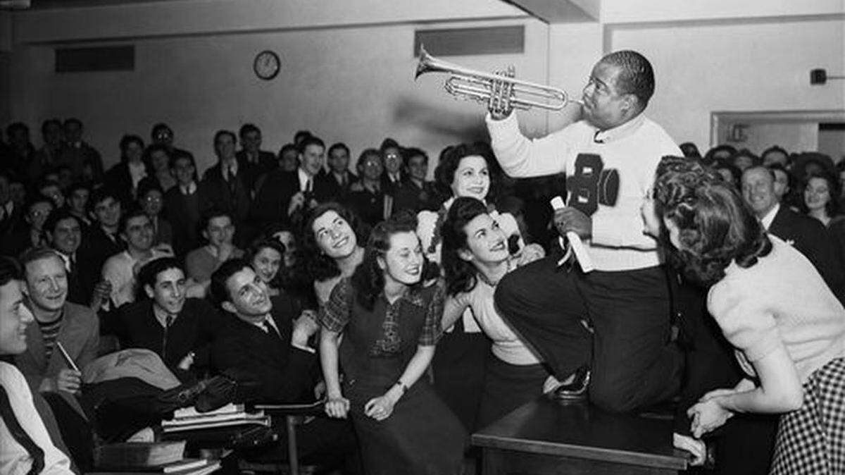 FILE - In this March 12, 1941, file photo, Louis Armstrong, wearing a Brooklyn College sweater, performs on the campus in New York as the school honored him with the degree "Doctor of Swing." Armstrong, Placido Domingo, Yo-Yo Ma, Audra McDonald, Leontyne Price and Harold Prince are this year's selections for the Performing Arts Hall of Fame at Lincoln Center. Jed Bernstein, president of Lincoln Center for the Performing Arts, made the announcement Thursday, Feb. 11, 2016. The honorees will be inducted June 20 during a ceremony at Lincoln Center's Alice Tully Hall.