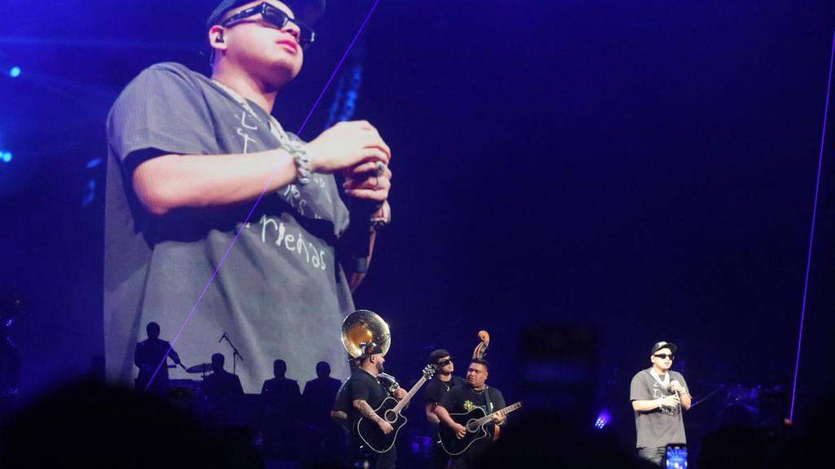 A video dwarfs Fuerza Regida during its sold-out concert at the Save Mart Center on Aug. 5, 2023.