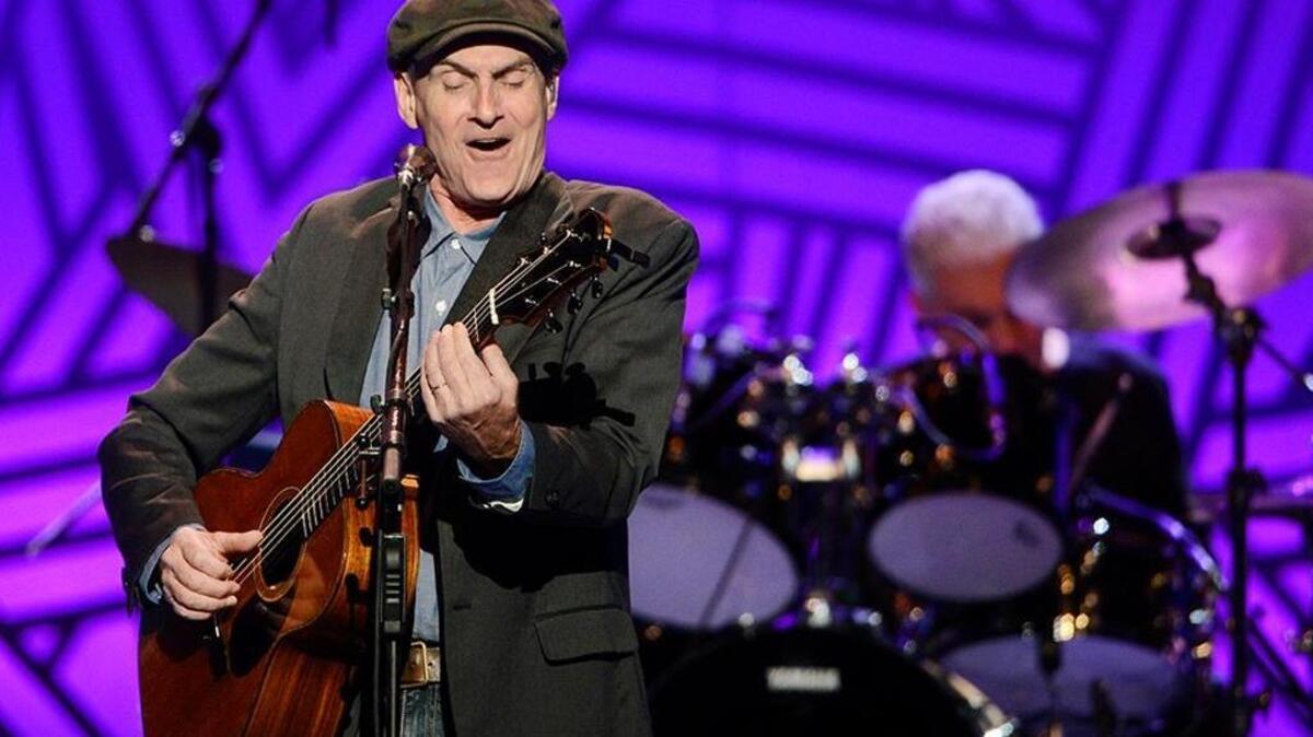 James Taylor performs with his band at the Save Mart Center, Tuesday, July 12, 2016.