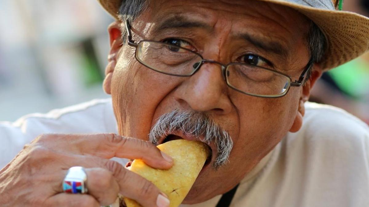 Fresno’s Héctor Cortez bites into a carne asada taco from La Jacko Mobile at Taco Truck Throwdown 6. This year’s event, expanded to two days, continues today.