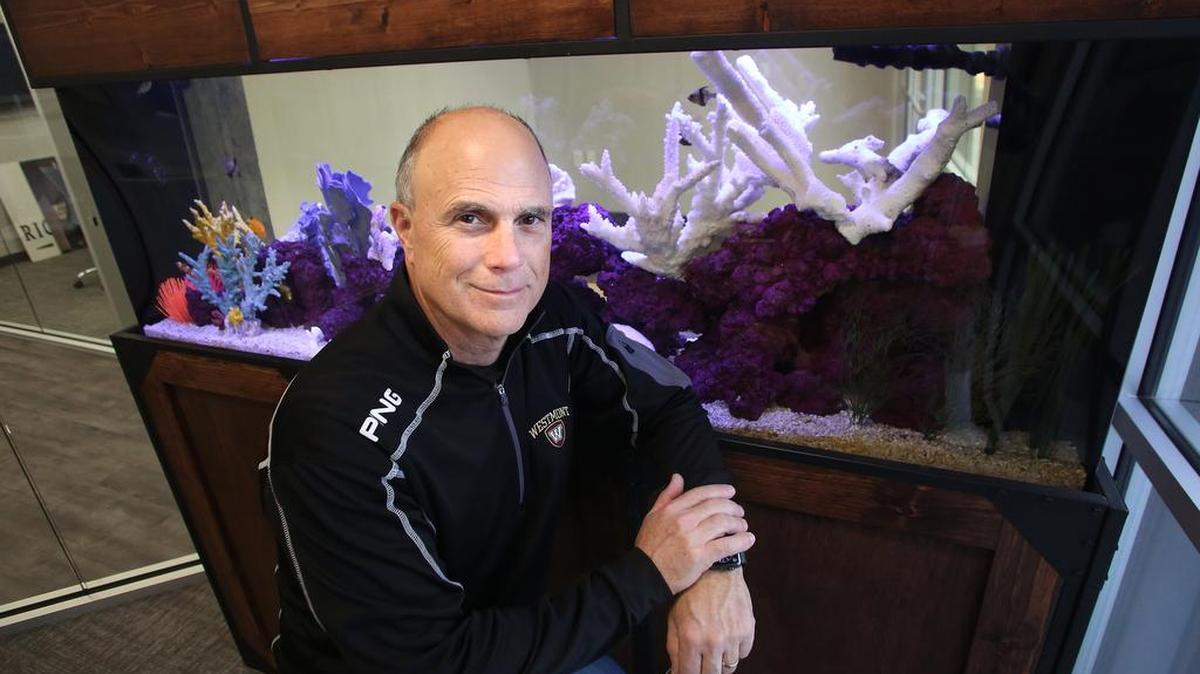 Rick Martin, a branch manager at LPL Financial, is shown with the saltwater aquarium installed in his office Friday, Feb. 22 2019 in Fresno.
