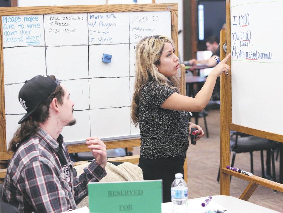 TUTORIAL CENTER: Vanessa Lopez helps Miles Wippert at the Fresno City College Tutorial Center.