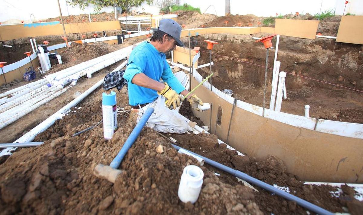 POOL BUILDER: Raul Espinoza works on a custom pool creation from Vineyard Pools, which does commercial work all over California, and residential work from Madera to Kingsburg, including Sanger and Oakhurst.