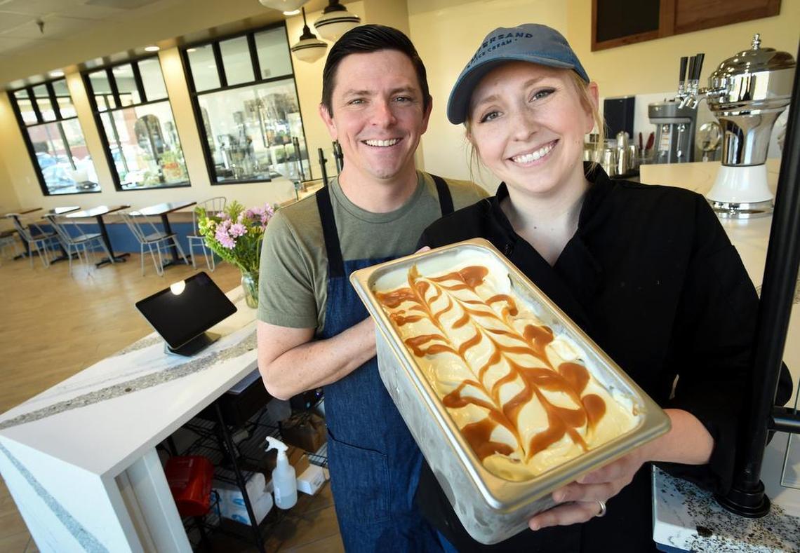 DESSERTS: Ampersand ice cream shop owners Jeff and Amelia Bennett hold a fresh batch of their whiskey caramel swirl ice cream at their new location at Herndon and Marks avenues.