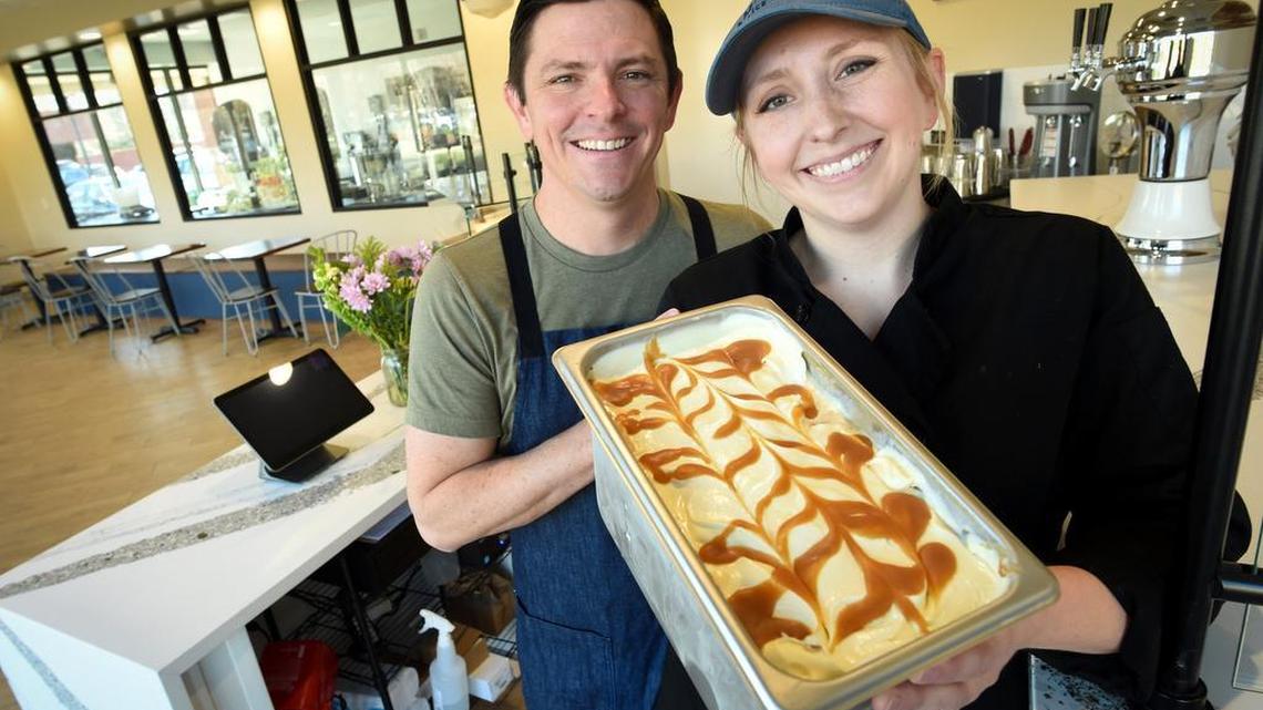 Ampersand ice cream shop owners Jeff and Amelia Bennett hold a fresh batch of their whiskey caramel swirl ice cream at their new location at Herndon and Marks avenues in this file photo from 2019.