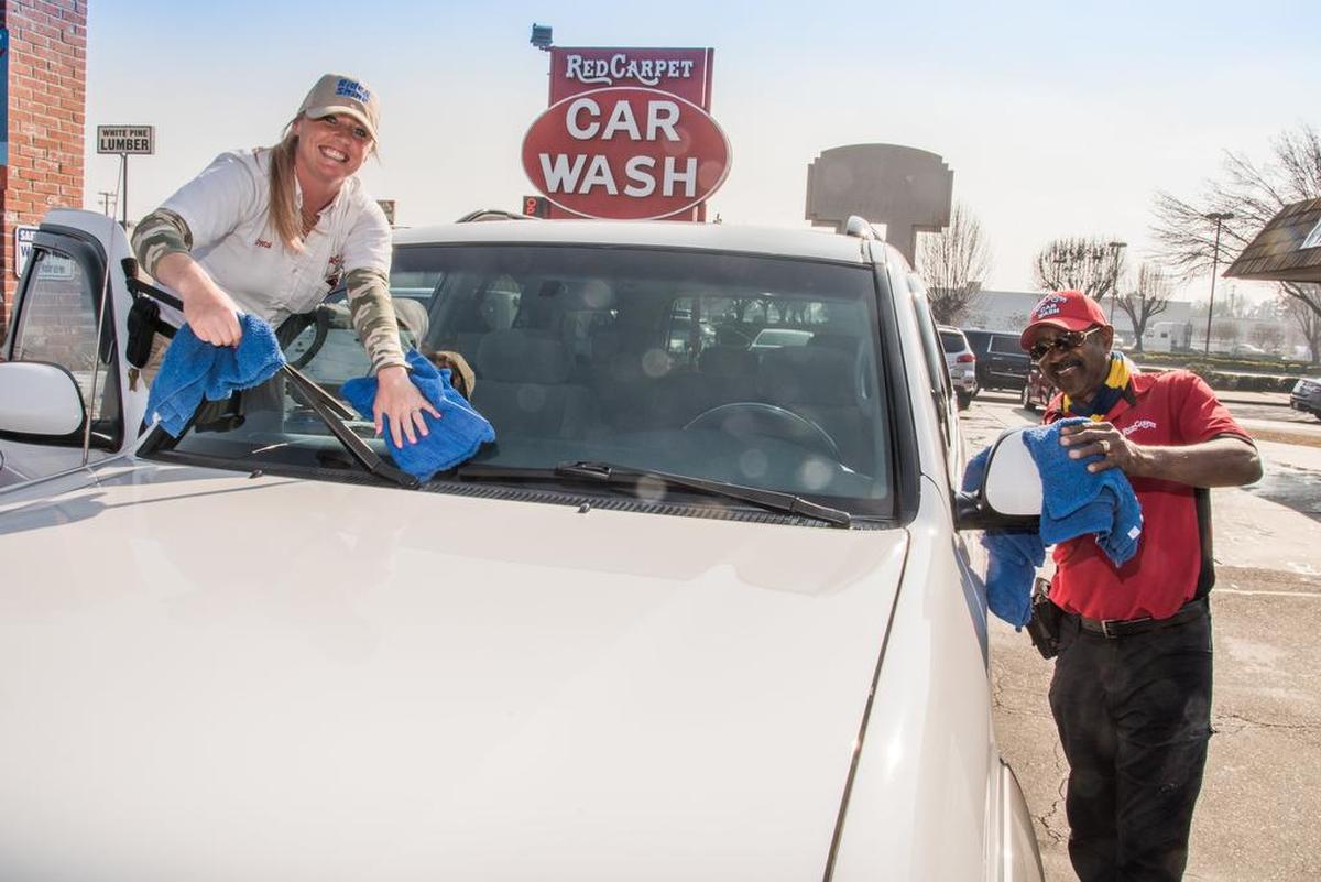 CAR WASH: Red Carpet Car Wash employees Crystal Western and Elvoyde White dry a newly clean car.