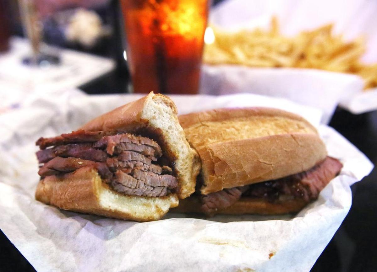 SPORTS BAR: A barbecue Tri-Tip sandwich, fries and a drink is a popular item at The Doghouse Grill, the People's Choice winner for Sports Bar.