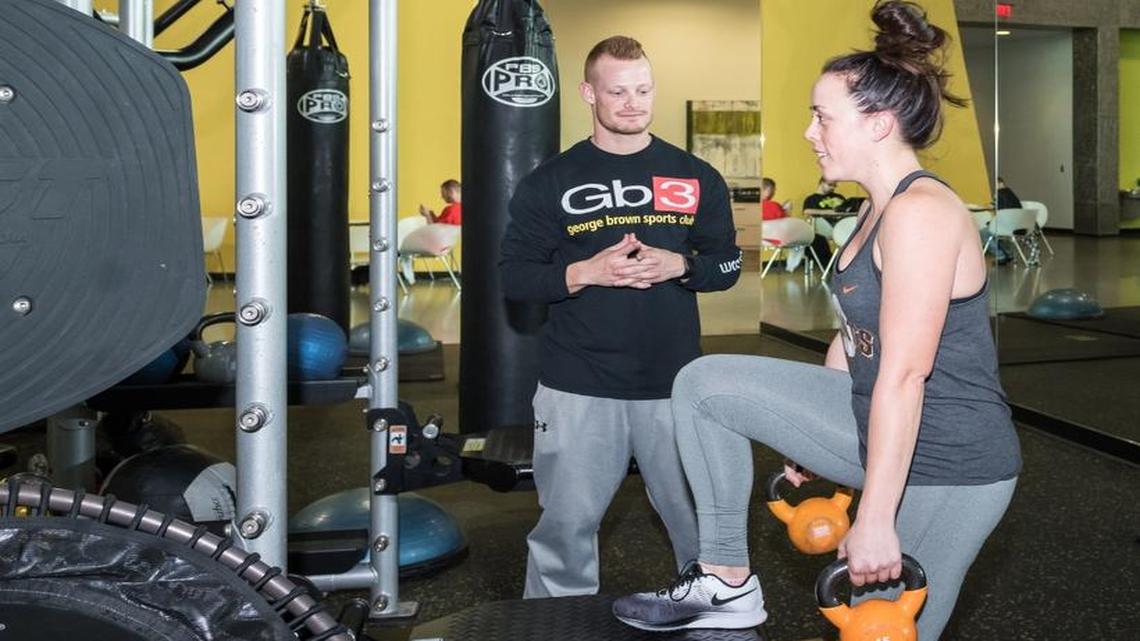 ATHLETIC CLUB: GB3 Trainer Nate Achelpohl provides personal training to Sarah Babcock as she works out.