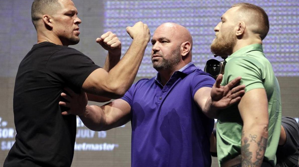 Nate Diaz, left, and Conor McGregor are set to fight in UFC 202. Dana White is at center.