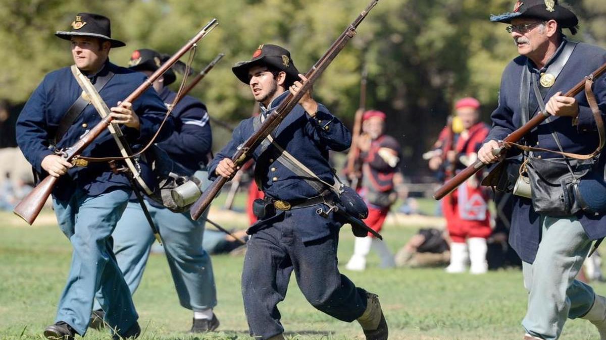 Union Army re-enactors move in on the Confederate Army during the battle re-enactment at the 25th anniversary of the Civil War Revisited at Kearney Park on Saturday, Oct. 18, 2014. The annual event is a presentation of the Fresno Historical Society and The American Civil War Association.