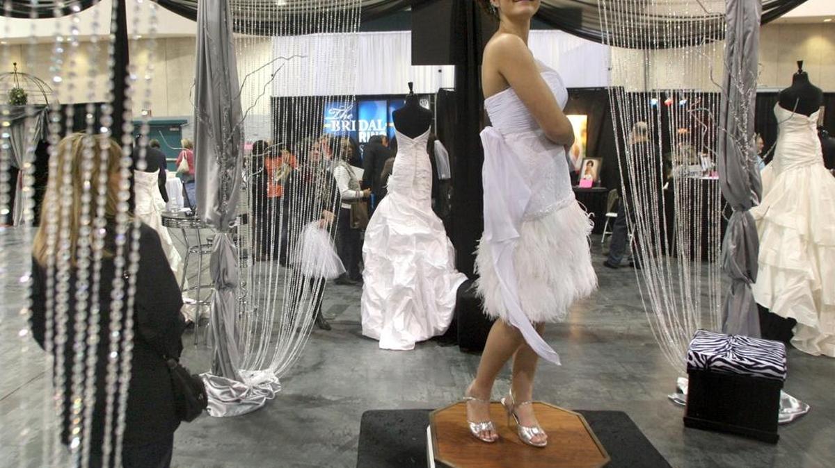 In this 2011 file photo, Candace Krebsbach of Visalia models a wedding dress during the Premier Bride Showplace at the Fresno Convention Center.