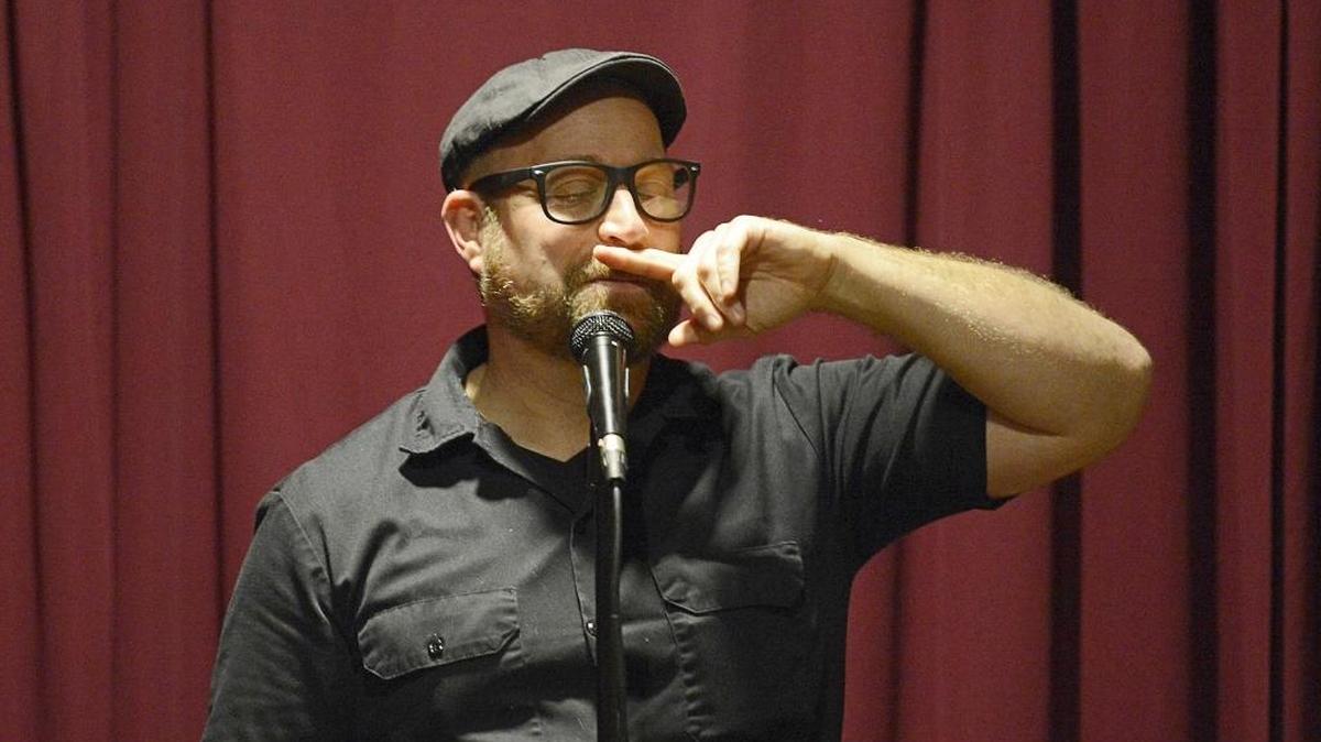 Local comedian Danny Minch holds back after joking with audience members.