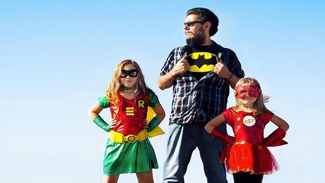 
Michael “MJ” Ramirez poses with his two super-daughters, Robin (Sophie) and The Flash (Alison). 
