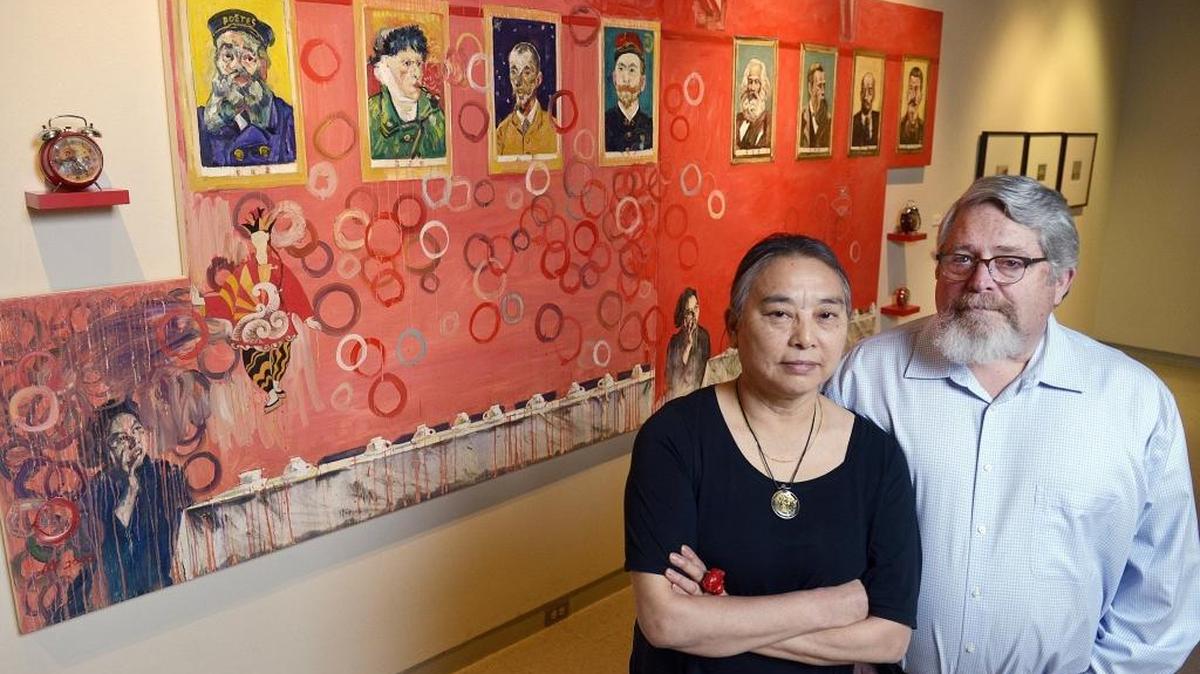 Chinese-American artist Hung Liu stands wih her husband, curator Jeff Kelley, near her work “Modern Time” displayed at the Fresno Art Museum.