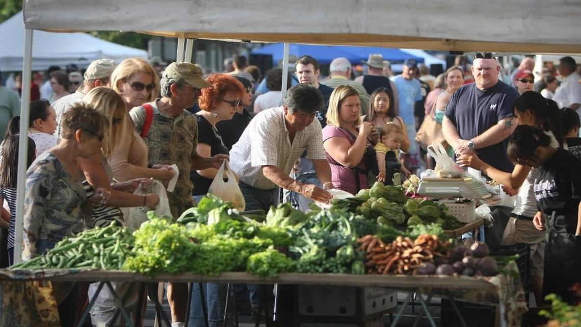 Customers line up at a Friday night farmers market in Old Town Clovis.