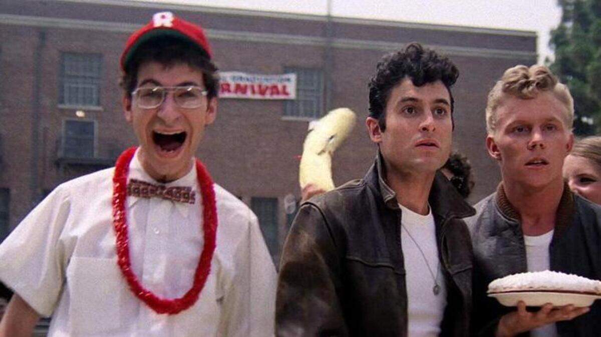 Actor Eddie Deezen, left in a scene from “Grease,” will host a “Grease” sing-along screening in Fresno on July 27 at the Historic Crest Theater. Deezen played Eugene in the classic movie musical, which was released in 1978.