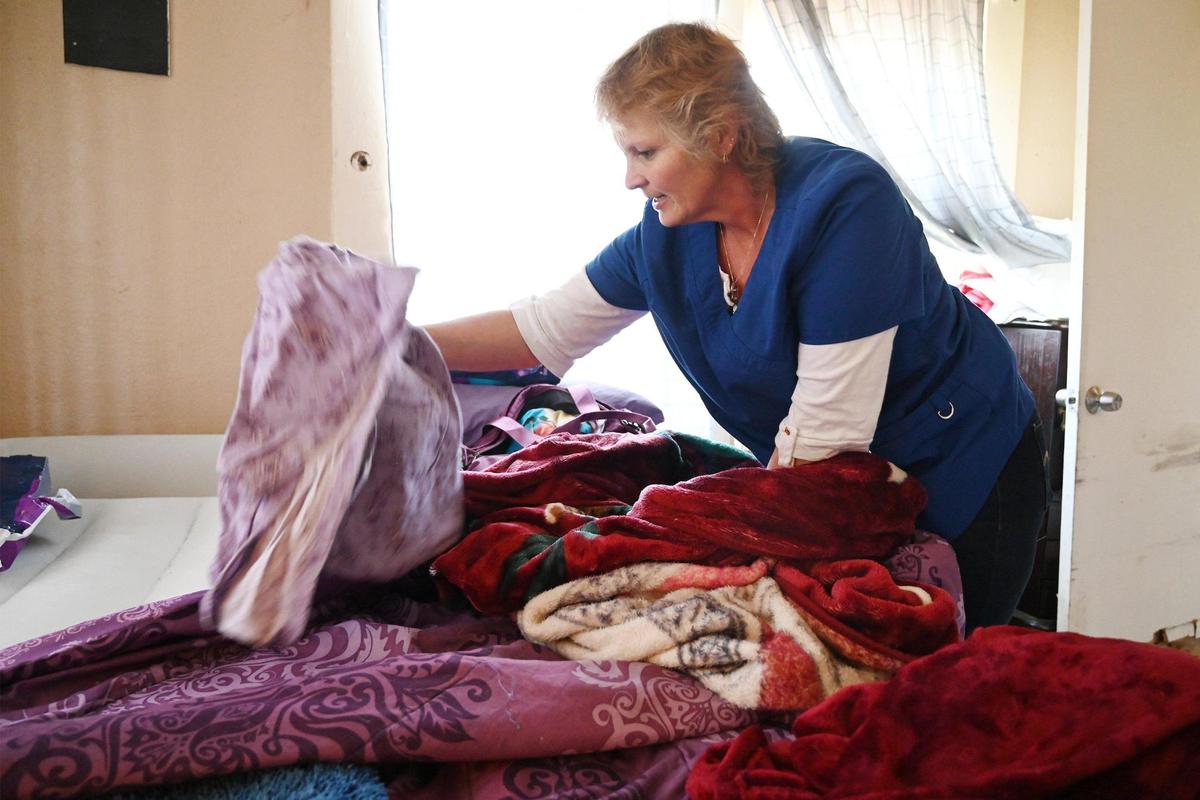 In-Home Support Services (IHSS) care worker Wendy Davenport makes the bed for her client Jovonna “JoJo” Martinez Wednesday, March 15, 2023 in Fresno. Davenport and other SEIU workers are looking for a salary increase from $16.10/hour to $20/hour for the work they do.