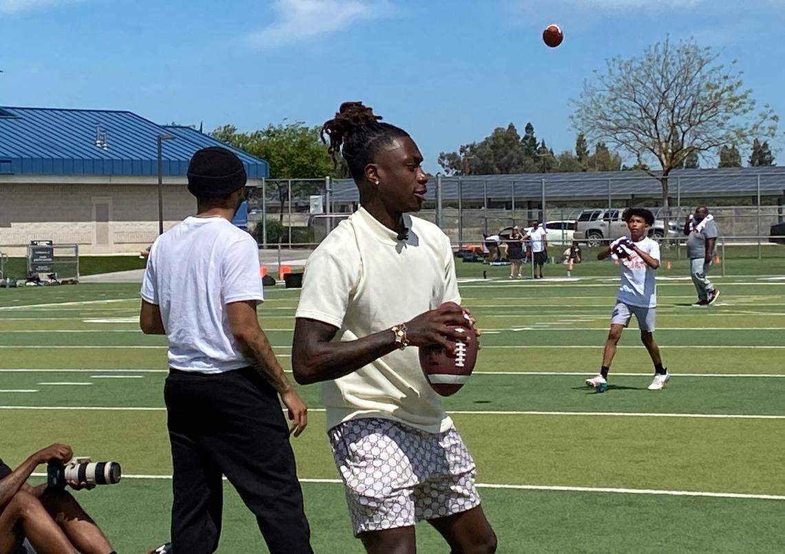 Xavier Worthy throws a pass at his youth camp on Saturday, April 20, 2024.