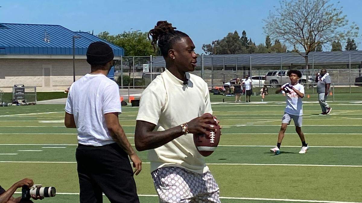 Xavier Worthy throws a pass at his youth camp on Saturday, April 20, 2024.