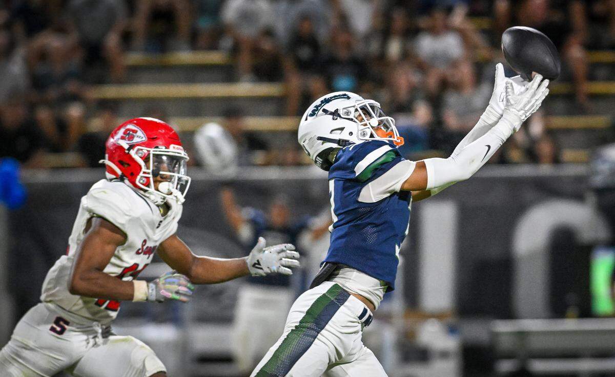 Clovis East wide receiver Marcellus Royal stretches out for the ball but is unable to come down with the catch while defended by Sanger’s Kayden Mcgrew during their game at Lamonica Stadium in Clovis on Friday, Sept. 5, 2025.
