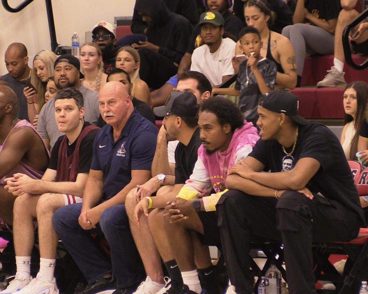 Miami Heat center Orlando Robinson, bottom right, Fresno Mayor Jerry Dyer and Jose Ramirez watch players on the court at Fresno City College on Sunday, July 30, 2023.