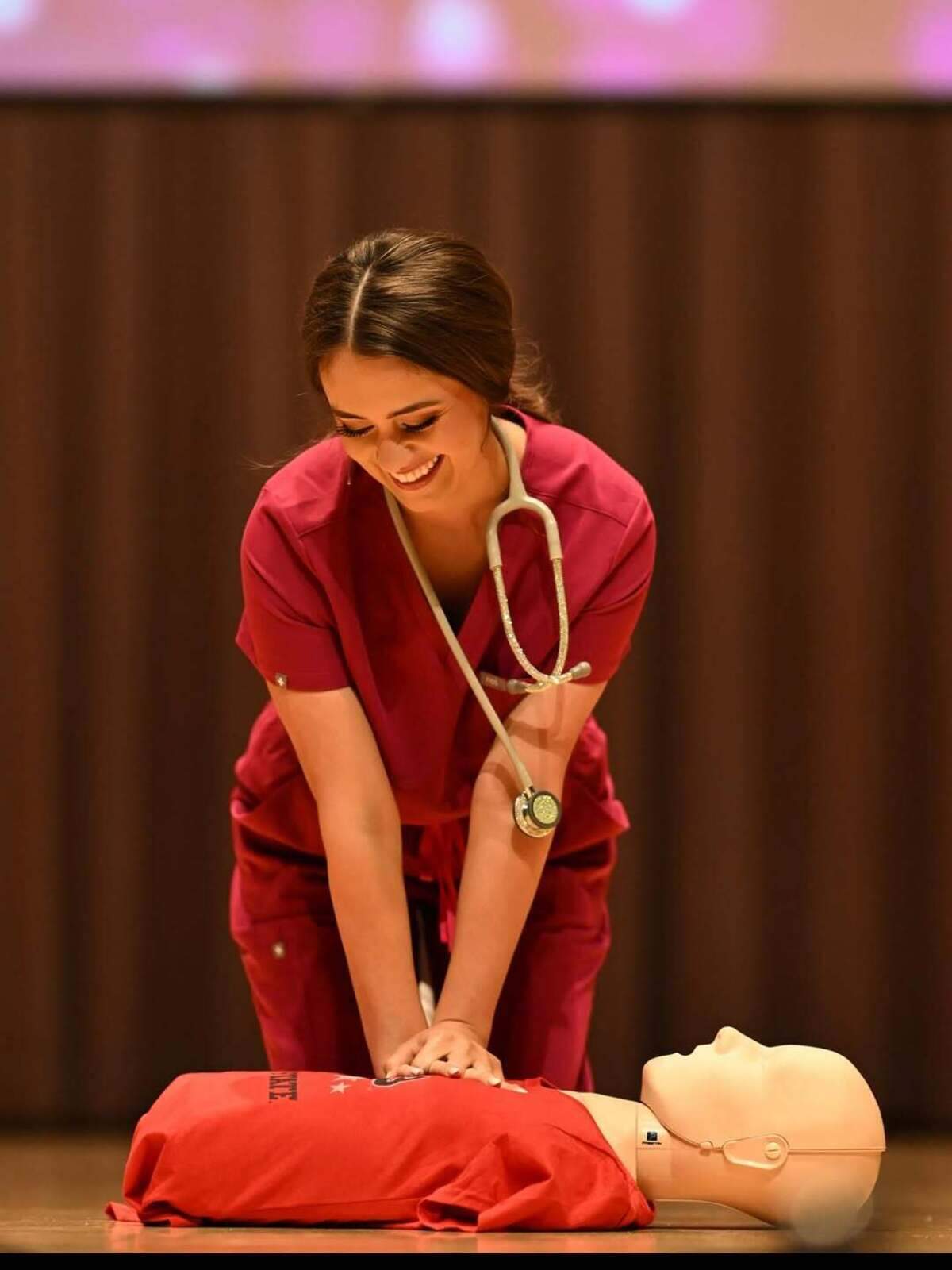 Miss Yosemite Valley Kiley Pastori, a nursing student, demonstrates CPR on stage.