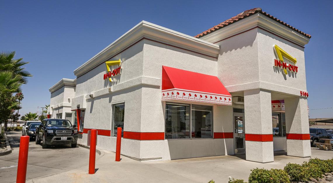 Cars wait at the drive-thru window at In-N-Out Burger on west Shaw Avenue near Highway 99 in Fresno on Monday, Aug. 7, 2023. Traffic issues have occurred in the area for years as vehicles wait in the drive-thru line. But the business just received approvals to increase the length of the drive-thru and add 37 parking spaces.