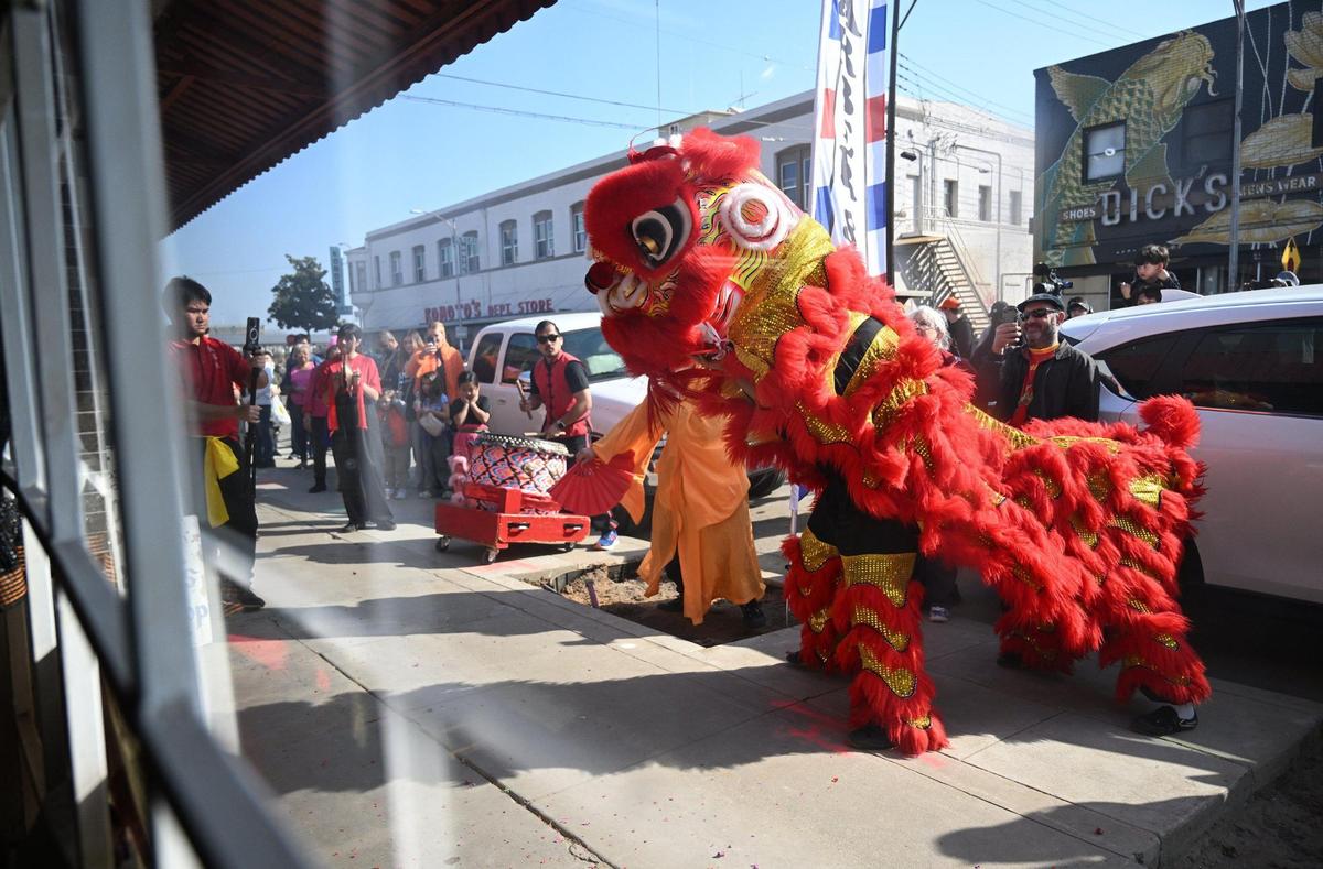 The Chinese New Year Lion Dancers prepare to enter a business on Kern Street welcoming good luck and prosperity for the coming year Saturday morning, Jan. 25, 2025 in Fresno’s Chinatown.
