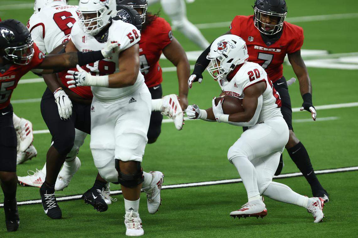 Fresno State running back Ronnie Rivers cuts behind a block by guard Dante Adkins Jr. in the Bulldogs’ 40-27 victory at UNLV Saturday, Nov. 7, 2020. Rivers scored four touchdowns in the victory, one off the school record.
