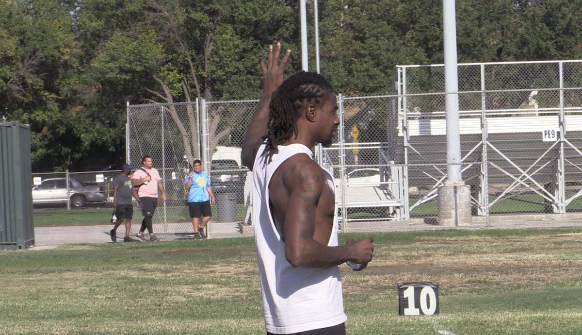 Former Fresno State standout and NFL player Bernard Berrian goes over plays during the Roosevelt High football practice on Monday, May 22, 2022.
