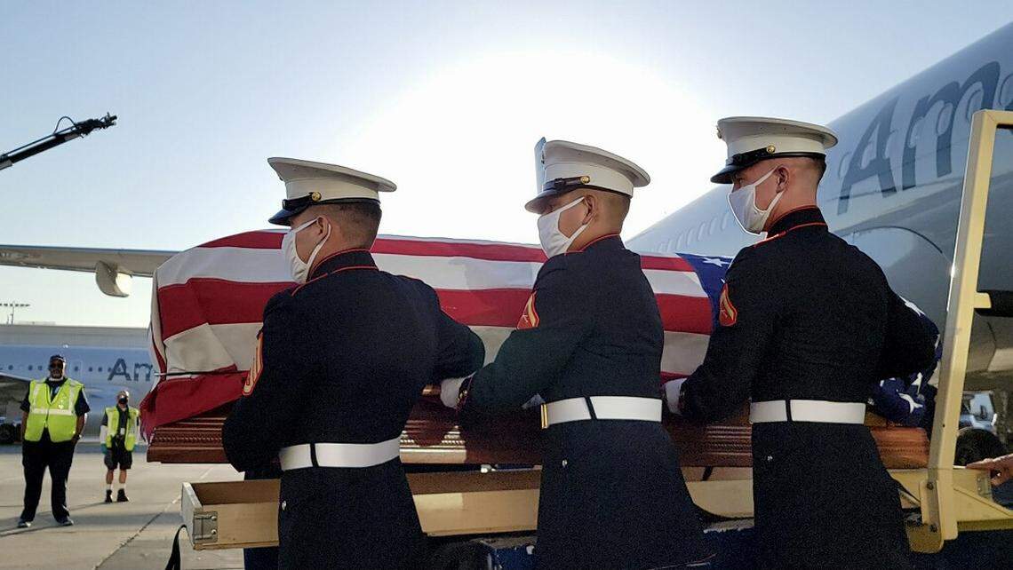 Marines carrying the remains of Pfc. Royal Waltz, killed during World War II, on Sept. 23, 2021 from an American Airlines plane at Los Angeles International Airport to a hearse that would transport them to a funeral home in Hanford.
